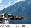 Hallstatt Village on a Lake with Alpine Mountains in Austria. 142630908