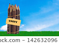 Bundle of wooden pencils with unity word on blue sky background 142632096