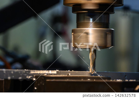 Slot cutting operation on an aluminum plate using a flat nose end mill tool on a milling machine Slot cutting operation on an aluminum plate using a flat nose end mill tool on a milling machine 142632578