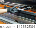 Operation of a hydraulic bending machine by a skilled technician working with sheet metal 142632584