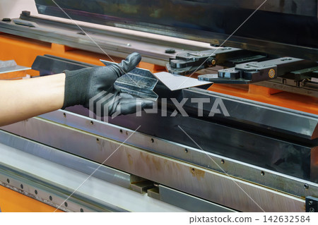 Operation of a hydraulic bending machine by a skilled technician working with sheet metal Operation of a hydraulic bending machine by a skilled technician working with sheet metal 142632584