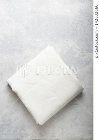 Folded Off White Linen Fabric on Concrete Surface Folded Off White Linen Fabric on Concrete Surface 142632666