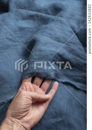 and Holding Slate Blue Linen Fabric and Holding Slate Blue Linen Fabric 142632692