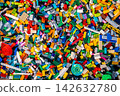 Top view A pile of multicolor of many Lego toy blocks in various shapes and different sizes. Toys and games. Leisure and recreation. 142632780