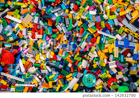 Top view A pile of multicolor of many Lego toy blocks in various shapes and different sizes. Toys and games. Leisure and recreation. Top view A pile of multicolor of many Lego toy blocks in various shapes and different sizes. Toys and games. Leisure and recreation. 142632780