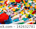 A pile of multicolor of many Lego toy blocks in various shapes and different sizes. Toys and games. Leisure and recreation. 142632781