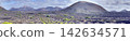 Vineyards in black volcanic soil beneath crater cones on Lanzarote 142634571