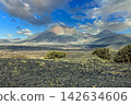 Rugged volcanic peaks and lava fields in Lanzarote landscape 142634606