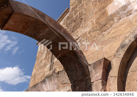 Odzun Church exterior details, Armenia. Sunlit ancient stone archway Odzun Church exterior details, Armenia. Sunlit ancient stone archway 142634848