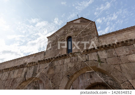 Historic stone church facade featuring rounded arches, Odzun Church 142634852
