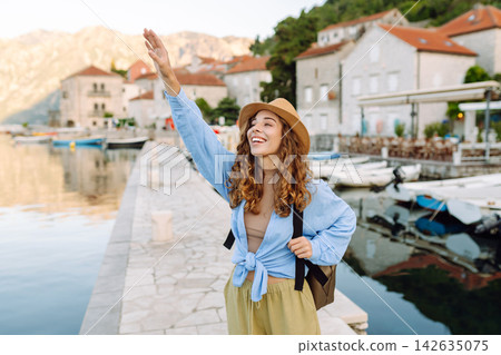 A tourist walks along embankment and looks at sights. Europe travel. Tourism, nature, active life. A tourist walks along embankment and looks at sights. Europe travel. Tourism, nature, active life. 142635075