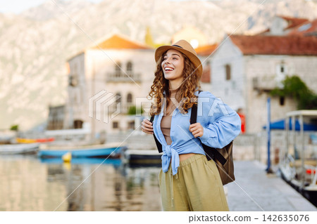 A tourist walks along embankment and looks at sights. Europe travel. Tourism, nature, active life. A tourist walks along embankment and looks at sights. Europe travel. Tourism, nature, active life. 142635076