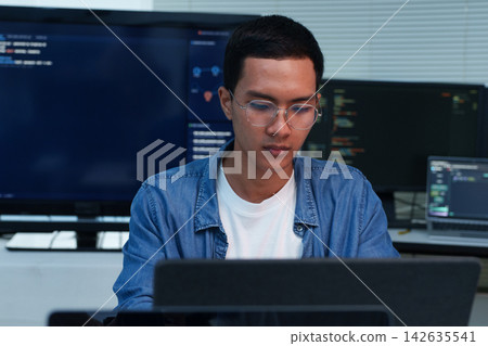Focused Programmer Working on Software Development Focused Programmer Working on Software Development 142635541