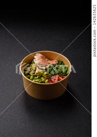 An Asian style bowl with shrimp, edamame, tomatoes, and wakame. A shrimp and vegetable bowl 142635625