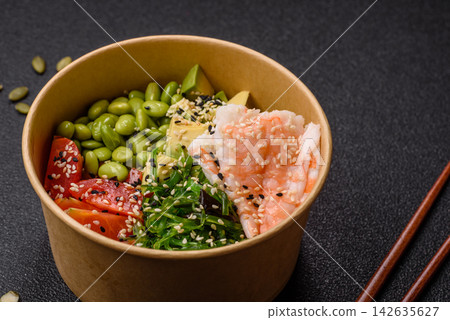 An Asian style bowl with shrimp, edamame, tomatoes, and wakame. A shrimp and vegetable bowl An Asian style bowl with shrimp, edamame, tomatoes, and wakame. A shrimp and vegetable bowl 142635627