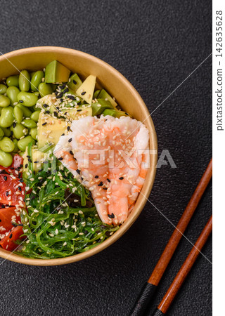 An Asian style bowl with shrimp, edamame, tomatoes, and wakame. A shrimp and vegetable bowl An Asian style bowl with shrimp, edamame, tomatoes, and wakame. A shrimp and vegetable bowl 142635628