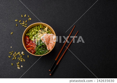 An Asian style bowl with shrimp, edamame, tomatoes, and wakame. A shrimp and vegetable bowl 142635630