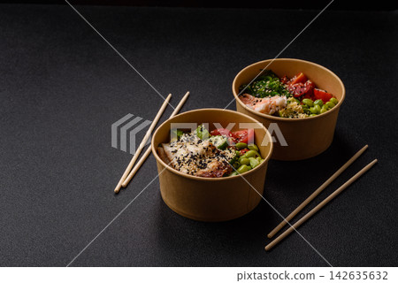 An Asian style bowl with shrimp, edamame, tomatoes, and wakame. A shrimp and vegetable bowl 142635632