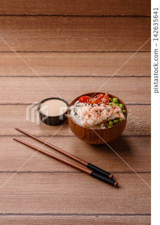 An Asian style bowl with shrimp, edamame, tomatoes, and wakame. A shrimp and vegetable bowl An Asian style bowl with shrimp, edamame, tomatoes, and wakame. A shrimp and vegetable bowl 142635641