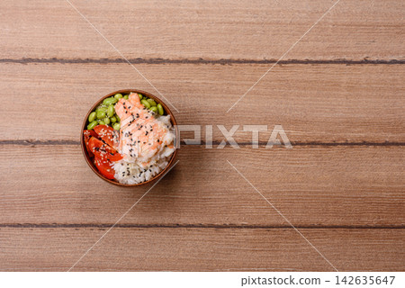 An Asian style bowl with shrimp, edamame, tomatoes, and wakame. A shrimp and vegetable bowl An Asian style bowl with shrimp, edamame, tomatoes, and wakame. A shrimp and vegetable bowl 142635647