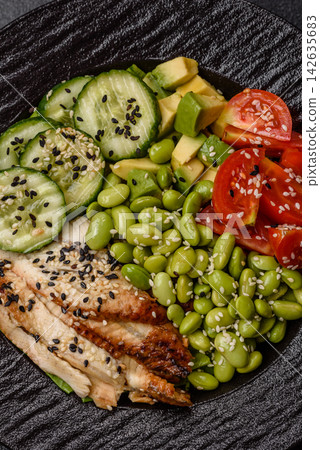 An Asian style bowl with eel, edamame, avocado, tomatoes, and lettuce. A eel and vegetable bowl An Asian style bowl with eel, edamame, avocado, tomatoes, and lettuce. A eel and vegetable bowl 142635683