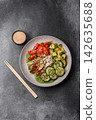 An Asian style bowl with eel, edamame, avocado, tomatoes, and lettuce. A eel and vegetable bowl 142635688