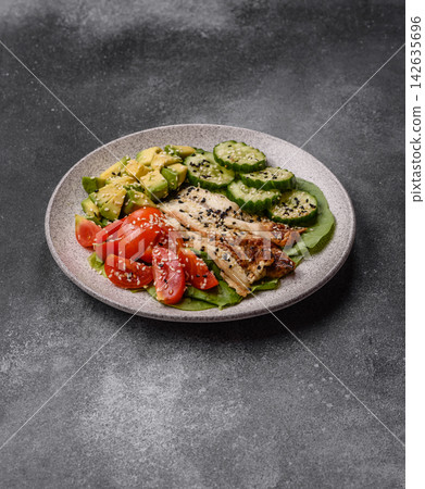 An Asian style bowl with eel, edamame, avocado, tomatoes, and lettuce. A eel and vegetable bowl An Asian style bowl with eel, edamame, avocado, tomatoes, and lettuce. A eel and vegetable bowl 142635696