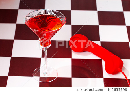 cosmopolitan cocktail, on a checkered table, with a vintage red pipe, no people cosmopolitan cocktail, on a checkered table, with a vintage red pipe, no people 142635798