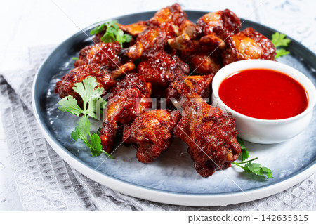 Crispy pieces of fried chicken, on a plate with sauce and herbs, in a modern kitchen environment, there are no people Crispy pieces of fried chicken, on a plate with sauce and herbs, in a modern kitchen environment, there are no people 142635815
