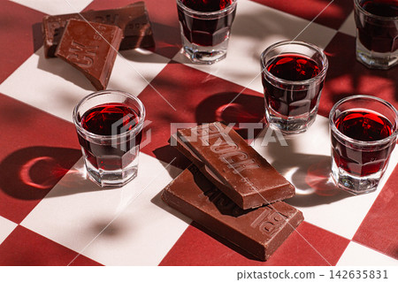 shots with chocolate wine, chess tiles on the table, hard light, no people, shots with chocolate wine, chess tiles on the table, hard light, no people, 142635831
