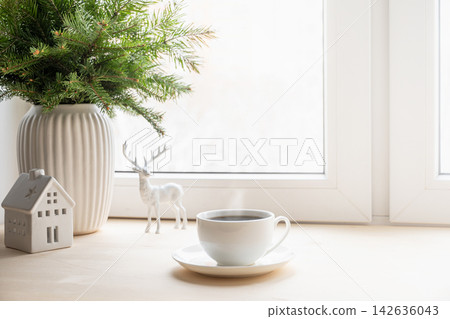 Christmas morning coffee by bright winter window Christmas morning coffee by bright winter window 142636043