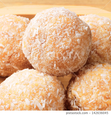 Homemade coconut beijinho inspired by Brazilian confectionery, a traditional sweet prepared for birthdays, parties, and special occasions. Homemade coconut beijinho inspired by Brazilian confectionery, a traditional sweet prepared for birthdays, parties, and special occasions. 142636045