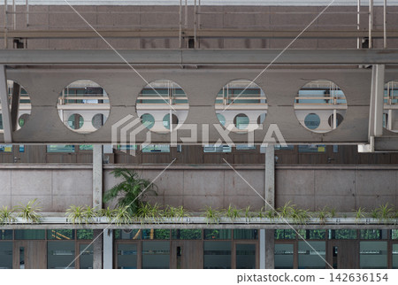 Industrial Brutalist Architecture with Castellated Steel Beams and Circular Cutouts, Contemporary Modular Building Facade with Textured Concrete and Urban Greenery, Abstract Geometric Layers of Modern Industrial Brutalist Architecture with Castellated Steel Beams and Circular Cutouts, Contemporary Modular Building Facade with Textured Concrete and Urban Greenery, Abstract Geometric Layers of Modern 142636154
