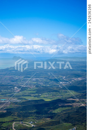 Sweeping mountain panorama revealing the sparkling Mediterranean Sea, Estepona and distant Gibraltar beneath open skies from Sierra Bermeja in Spain. Sweeping mountain panorama revealing the sparkling Mediterranean Sea, Estepona and distant Gibraltar beneath open skies from Sierra Bermeja in Spain. 142636166