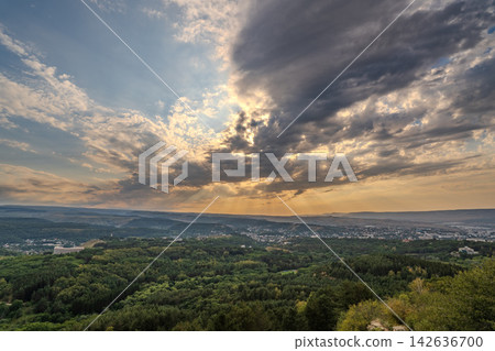 View of the mountains and Kislovodsk from the observation decks of the Kislovodsk Park. Evening sunset over the mountains of Kislovodsk. 142636700