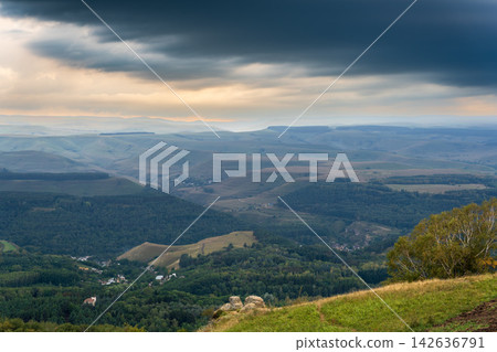 Layers of green mountains and hills in the haze during sunset. Panoramic View of Green hills and Meadow. Layers of green mountains and hills in the haze during sunset. Panoramic View of Green hills and Meadow. 142636791