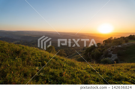 View of the mountains and Kislovodsk from the observation decks of the Kislovodsk Park. Evening sunset over the mountains of Kislovodsk. View of the mountains and Kislovodsk from the observation decks of the Kislovodsk Park. Evening sunset over the mountains of Kislovodsk. 142636824