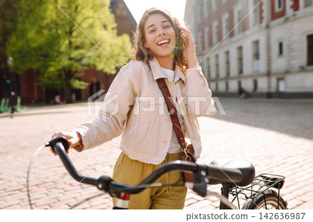 Happy woman tourist using bicycle in city street. Free time after work and study, lifestyle. Happy woman tourist using bicycle in city street. Free time after work and study, lifestyle. 142636987