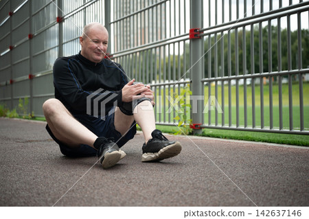 Mature man suffering from knee pain after workout Mature man suffering from knee pain after workout 142637146