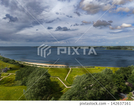High angle wide horizontal aerial drone photograph of Lake Veere shoreline, sandy beach, walking paths, star fort earthworks, and wind farm in Veere, Zeeland, Netherlands on overcast summer day High angle wide horizontal aerial drone photograph of Lake Veere shoreline, sandy beach, walking paths, star fort earthworks, and wind farm in Veere, Zeeland, Netherlands on overcast summer day 142637161