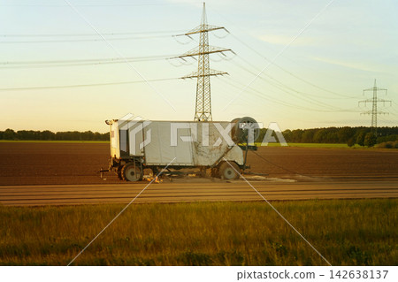 Abandoned vehicle under the golden sunset in a vast field Abandoned vehicle under the golden sunset in a vast field 142638137
