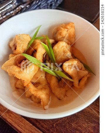 Delightful chuchvara served with fragrant green onions Delightful chuchvara served with fragrant green onions 142638154