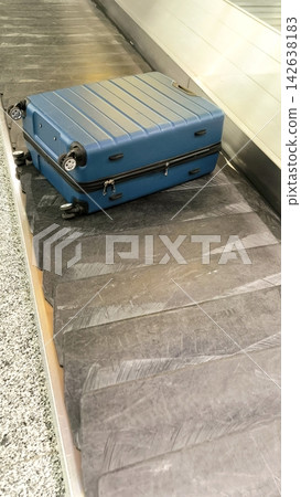 A single bag has arrived at the claim area. Travel, flight, and baggage logistics in the terminal A single bag has arrived at the claim area. Travel, flight, and baggage logistics in the terminal 142638183