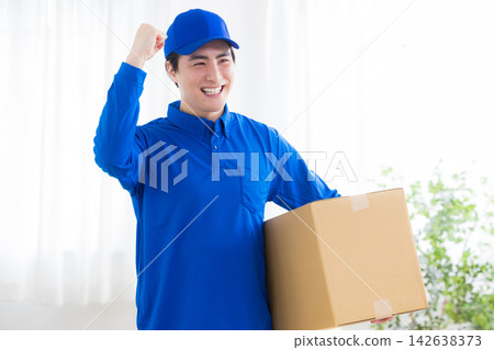 Worker with cardboard box Worker with cardboard box 142638373