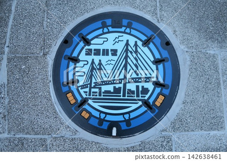 Manhole cover featuring a design of Yokohama's Bay Bridge Manhole cover featuring a design of Yokohama's Bay Bridge 142638461