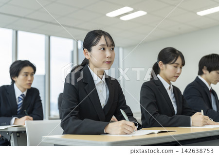 身著西裝的年輕男女正在參加研討會。 身著西裝的年輕男女正在參加研討會。 142638753