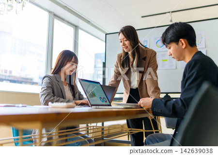 Business people conducting meetings while looking at their laptop screens. Business people conducting meetings while looking at their laptop screens. 142639038