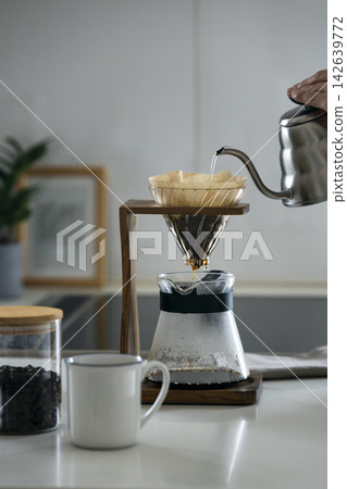 The person brewing the coffee The person brewing the coffee 142639772