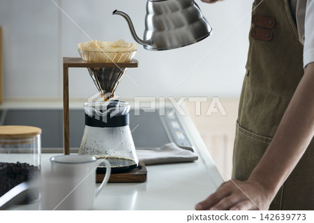 A man brewing coffee A man brewing coffee 142639773