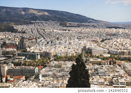Athens, Attica, Greece, beautiful panoramic view of Athens cityscape, with The Parthenon, mountains, sea and scenery beyond the city, seen from Mount Lycabettus Hill observation deck in a sunny day Athens, Attica, Greece, beautiful panoramic view of Athens cityscape, with The Parthenon, mountains, sea and scenery beyond the city, seen from Mount Lycabettus Hill observation deck in a sunny day 142640552
